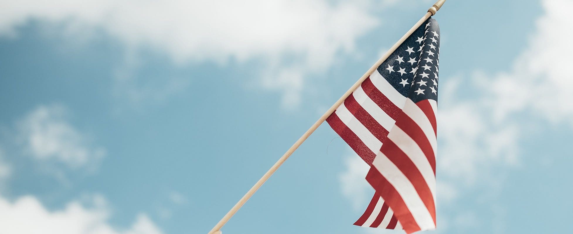 american flag waving in blue skies of summer american flag waving in blue skies of summer