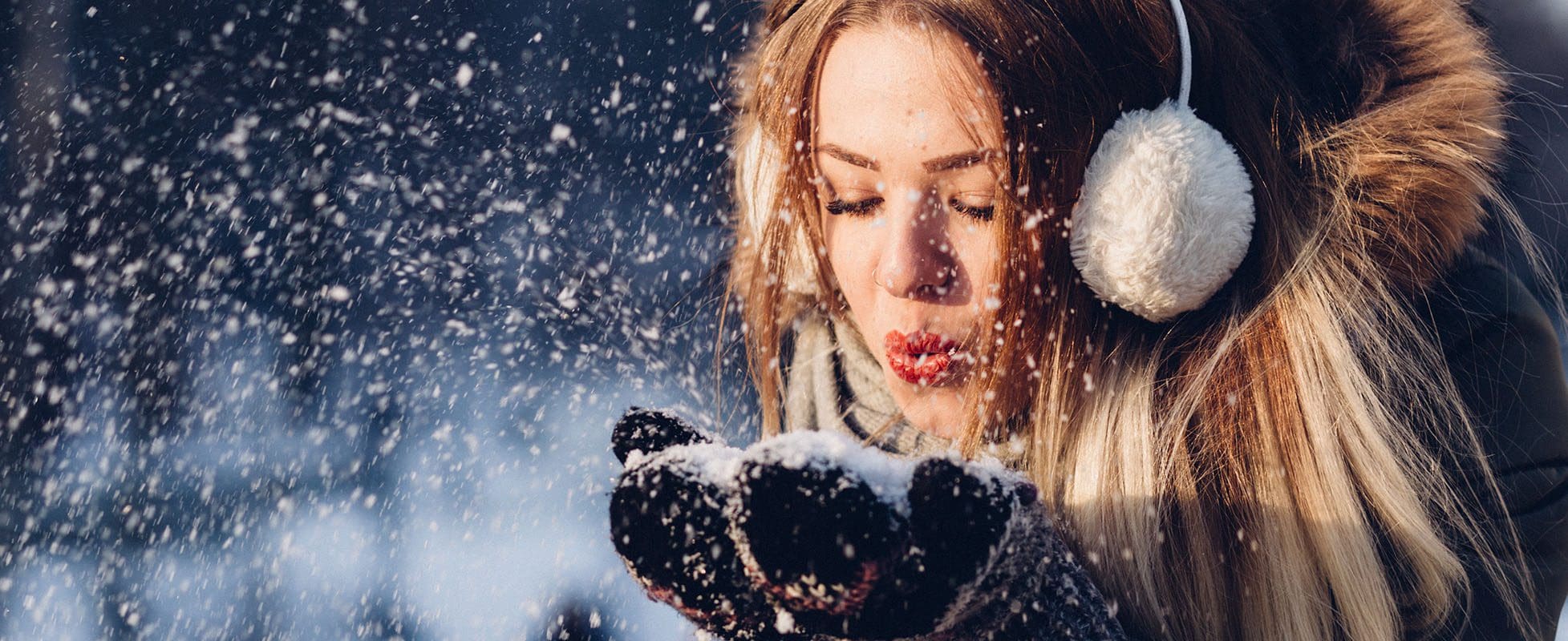 woman blowing snow in the air woman blowing snow in the air